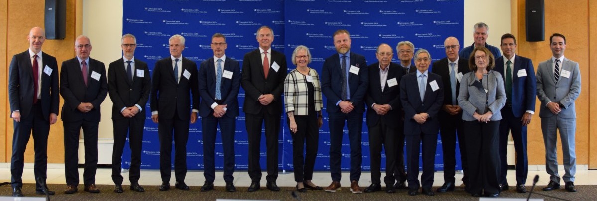Members of the entire panel standing together and smiling for a photo 
