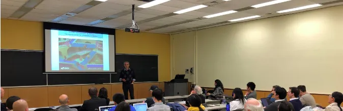 Classroom of students. Santiago Levy presenting to students with presentation 